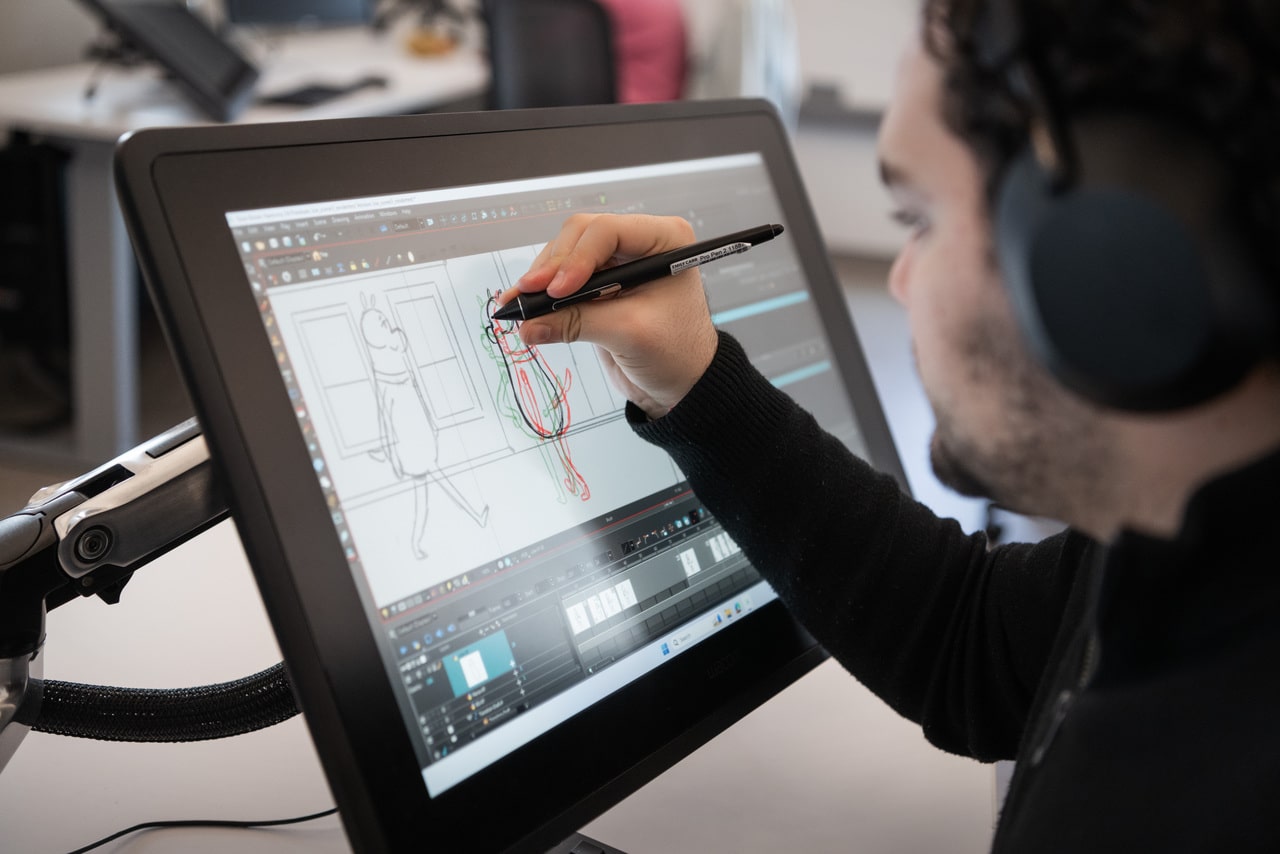 Animation student working on a design at a computer in the Communication Design Studio.