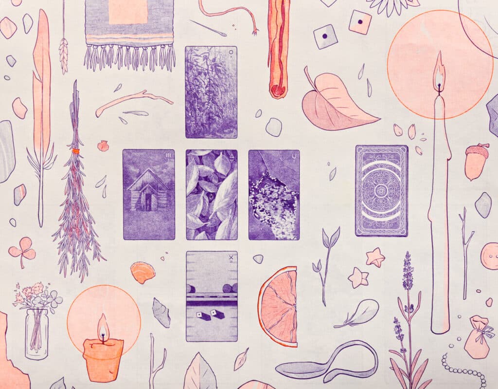Illustrated tarot-style cards arranged on patterned paper with drawings of plants, candles and objects in purple and orange