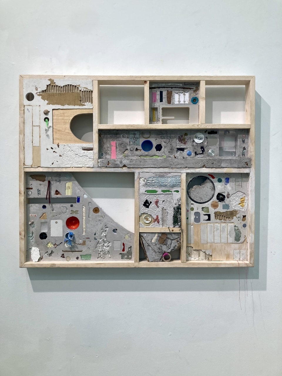 Mixed-media wall collage featuring two large tree stumps surrounded by leaves, ferns, mushrooms, and rocks, with the left side painted in vivid colour and the right side in black and white.