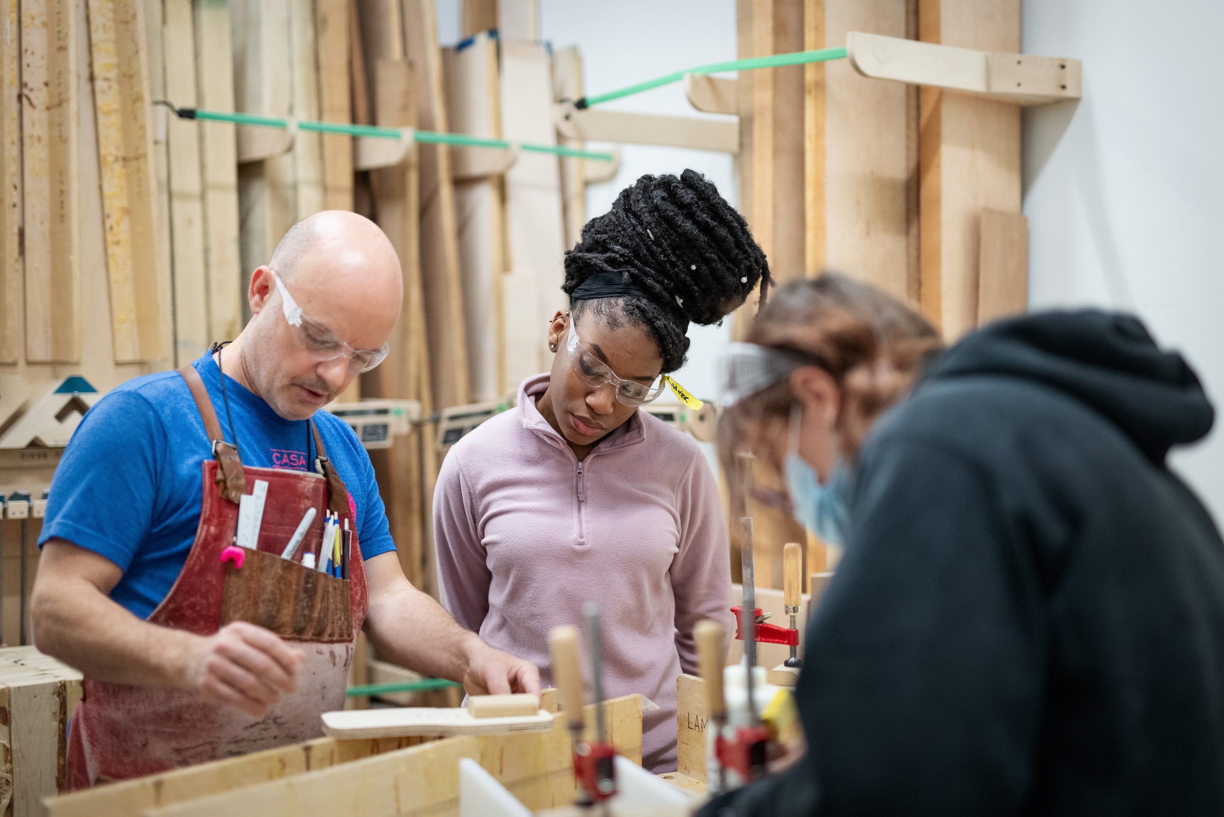 Technician and students clamping wood in the Design Wood Shop.