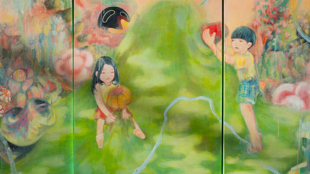 A colourful painting on wooden panels depicts two children in a dreamlike green landscape, one holding a pumpkin and the other reaching upward, surrounded by soft, abstract shapes.