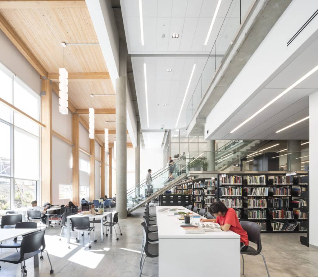 Interior photo of ECU’s campus architecture with wide open space, tall windows, and exposed beams.