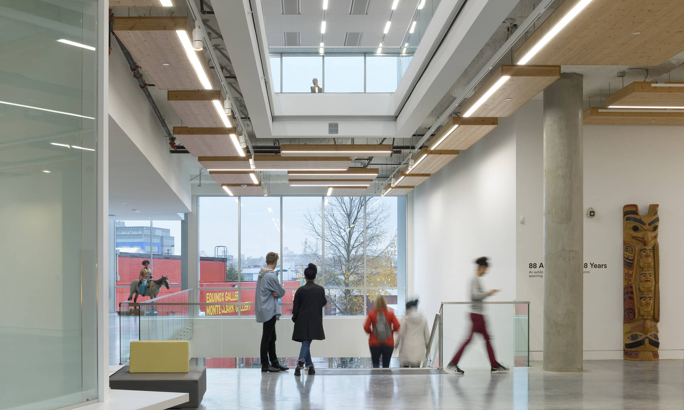 Interior photo of ECU’s campus architecture with wide open space, tall windows, and exposed beams.