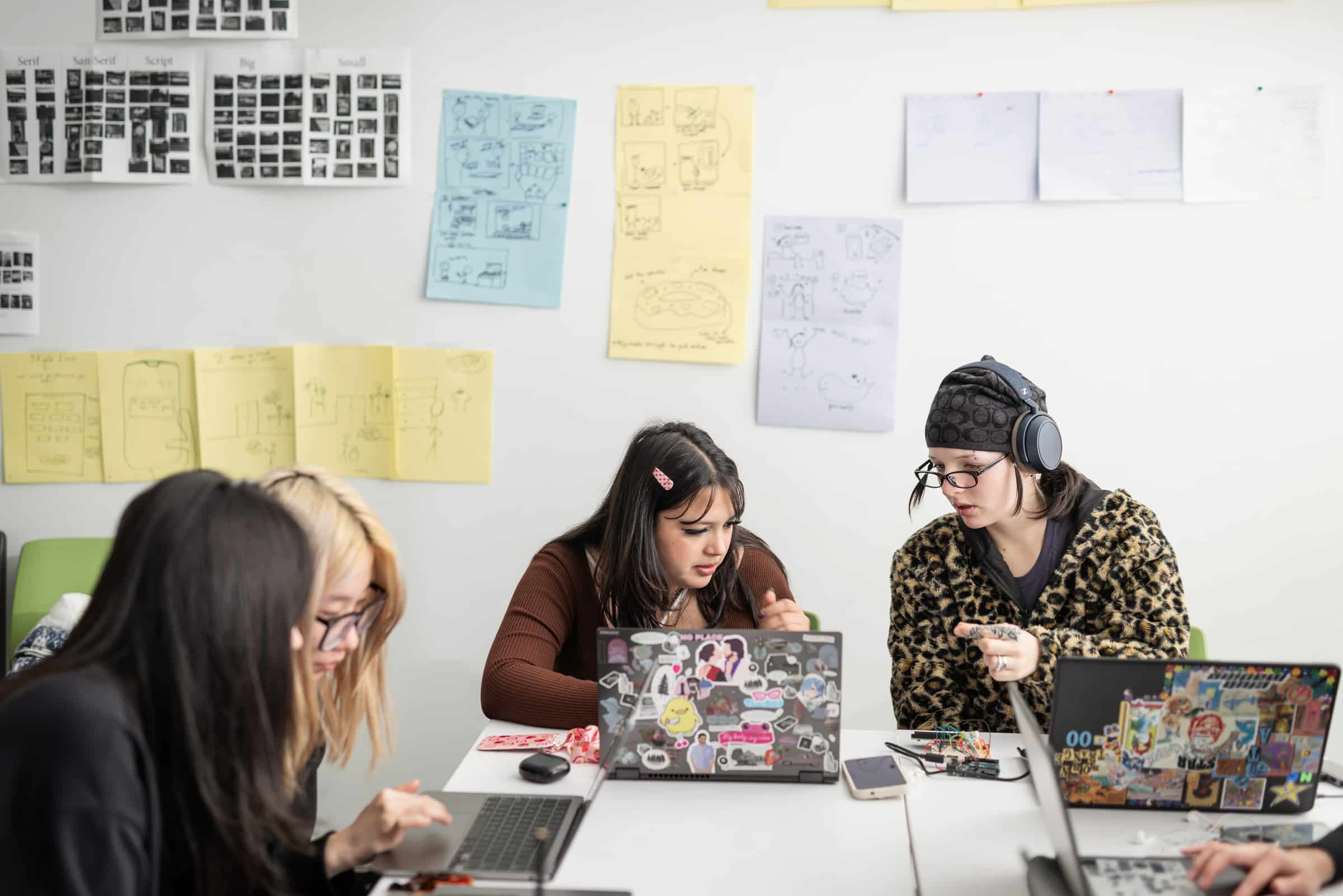 Students working together on laptops in the Interaction Design Lab.