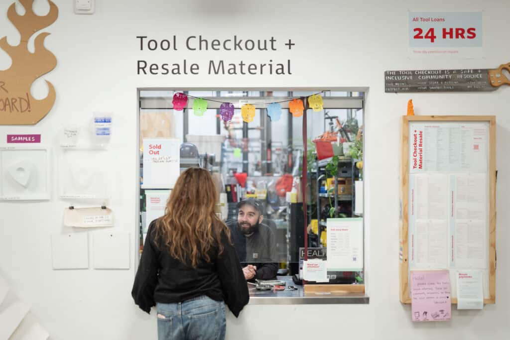 Tool Checkout attendant helping a customer at the service window.