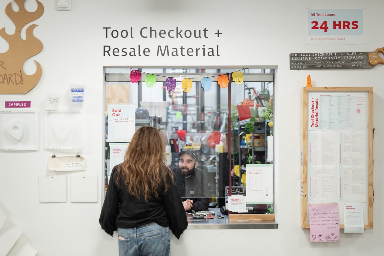 Tool Checkout attendant helping a customer at the service window.