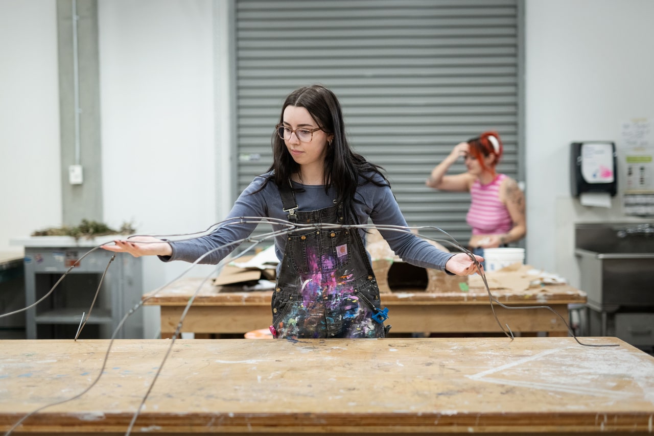 Student building a wire sculpture.