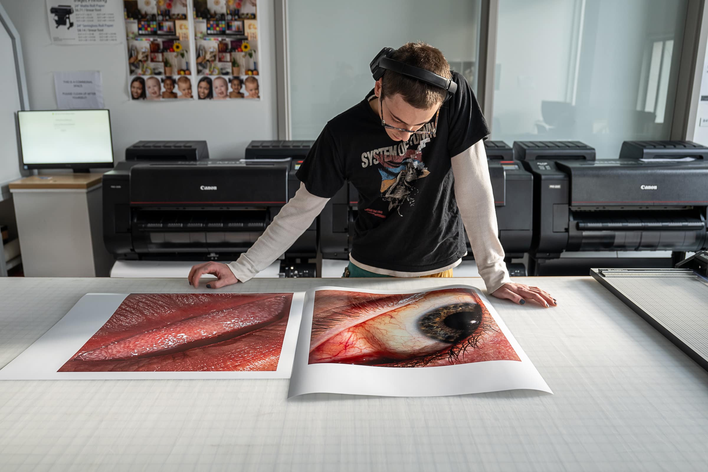 A photography student examines their work in the print lab on ECU's campus.