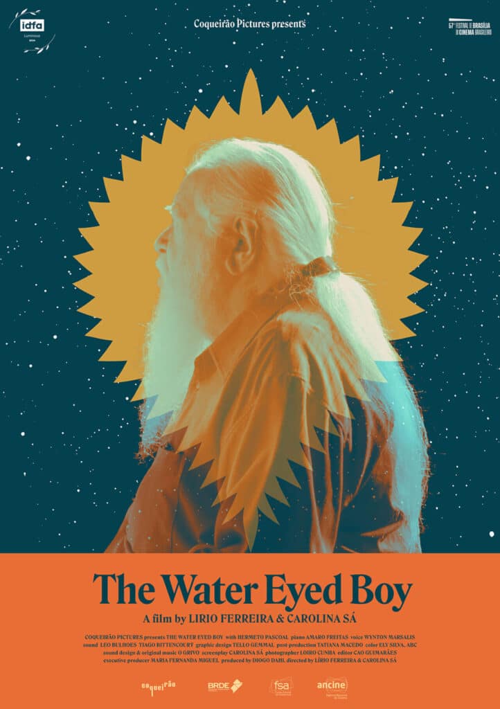 A movie poster features a profile of a man with long hair and a beard set against a starry night sky, framed by a golden sunburst with the title “The Water Eyed Boy.
