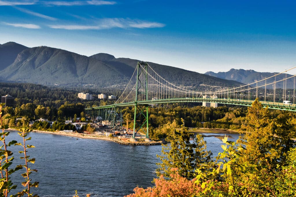 View of the Lions Gate Bridge stretching across Burrard Inlet, with the North Shore mountains rising in the background.