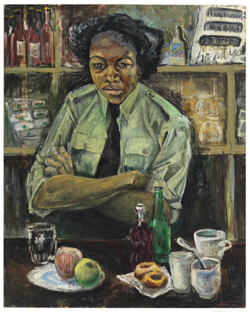 A woman in uniform sits with folded arms at a table set with fruit, cups, and bottles, looking directly at the viewer.
