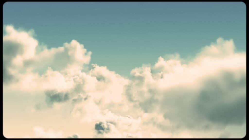 A film still showing sunlit clouds against a soft blue sky, rendered in warm, painterly digital animation.