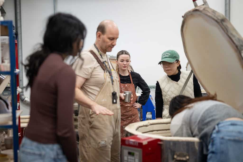 Ceramics students get a lesson on the kiln from one of ECU's studio technicians.