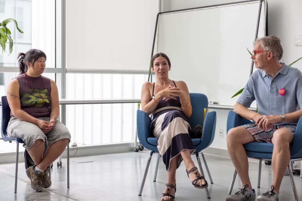 Three people sitting down and discussing