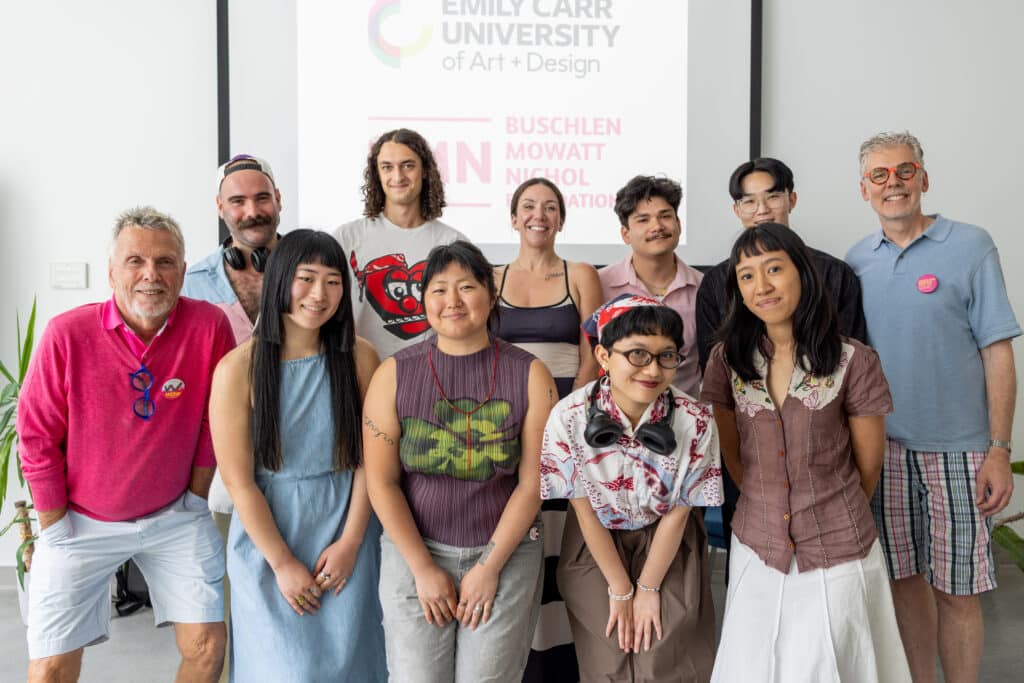 A group of people in two rows pose together