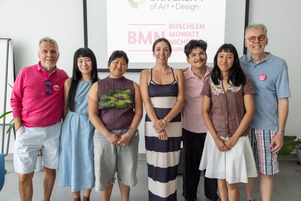 A group of 7 people standing together for a photo.