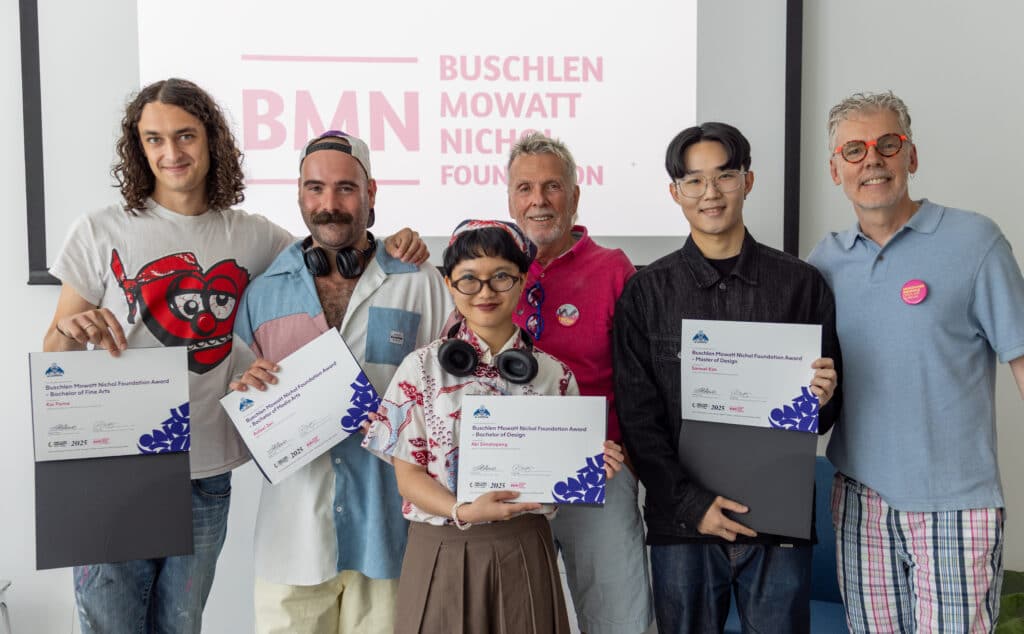 A group of 6 people with some members holding an award booklet out