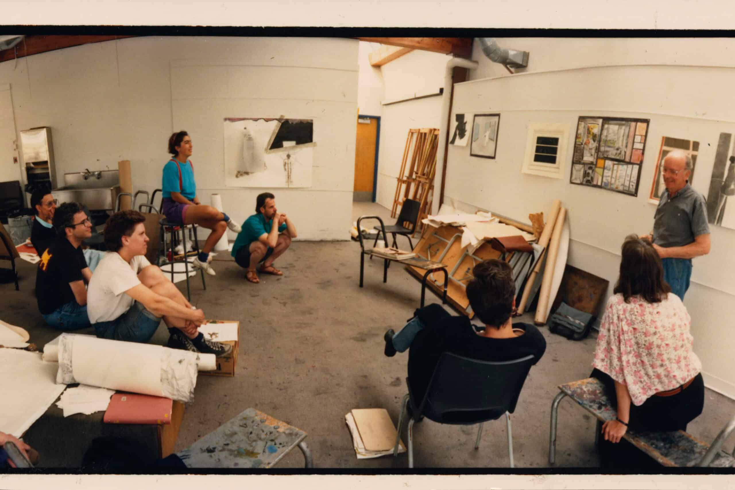 A group of students and a faculty member in a classroom on campus on Granville Island.