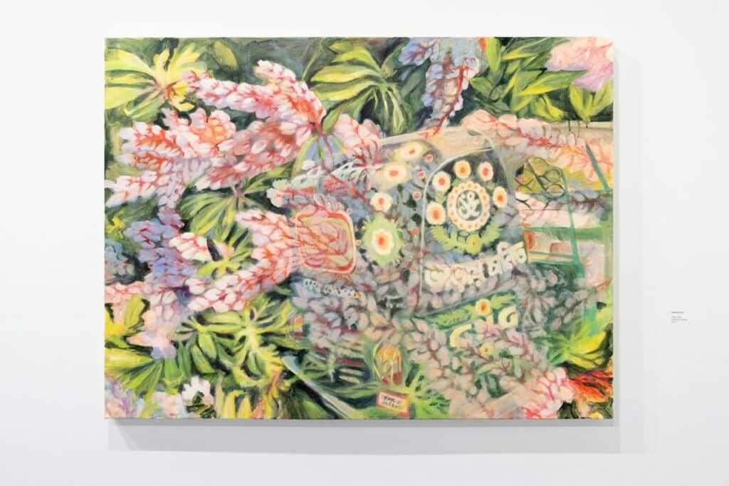 A large abstract painting filled with overlapping floral forms, leafy greens, and patterned shapes in soft pinks, yellows, and muted blues, creating a dense, garden-like composition.