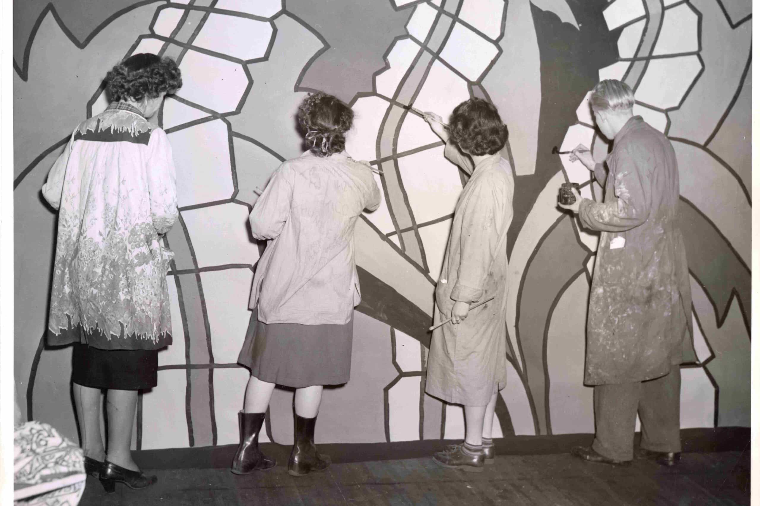 A group of students painting a mural at the Vancouver School of Art.