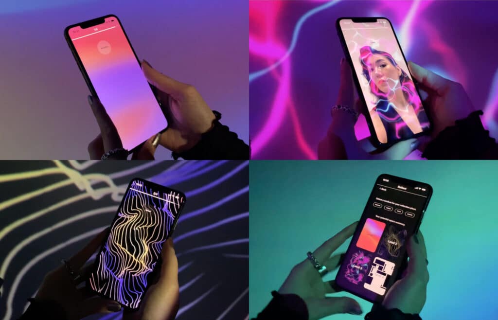 Hands hold a smartphone as shifting, colourful digital patterns and faces glow across the screen, casting soft light into the surrounding space.