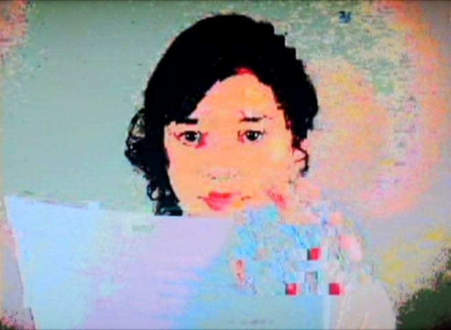 A low-resolution, pixelated portrait of a person with areas of visual interference and colour noise