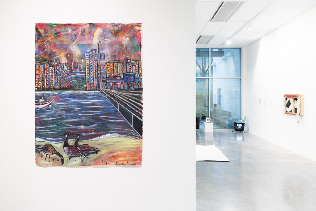 A large, vibrant painting of a waterfront city skyline with birds in the foreground hangs near a windowed corner of the gallery.