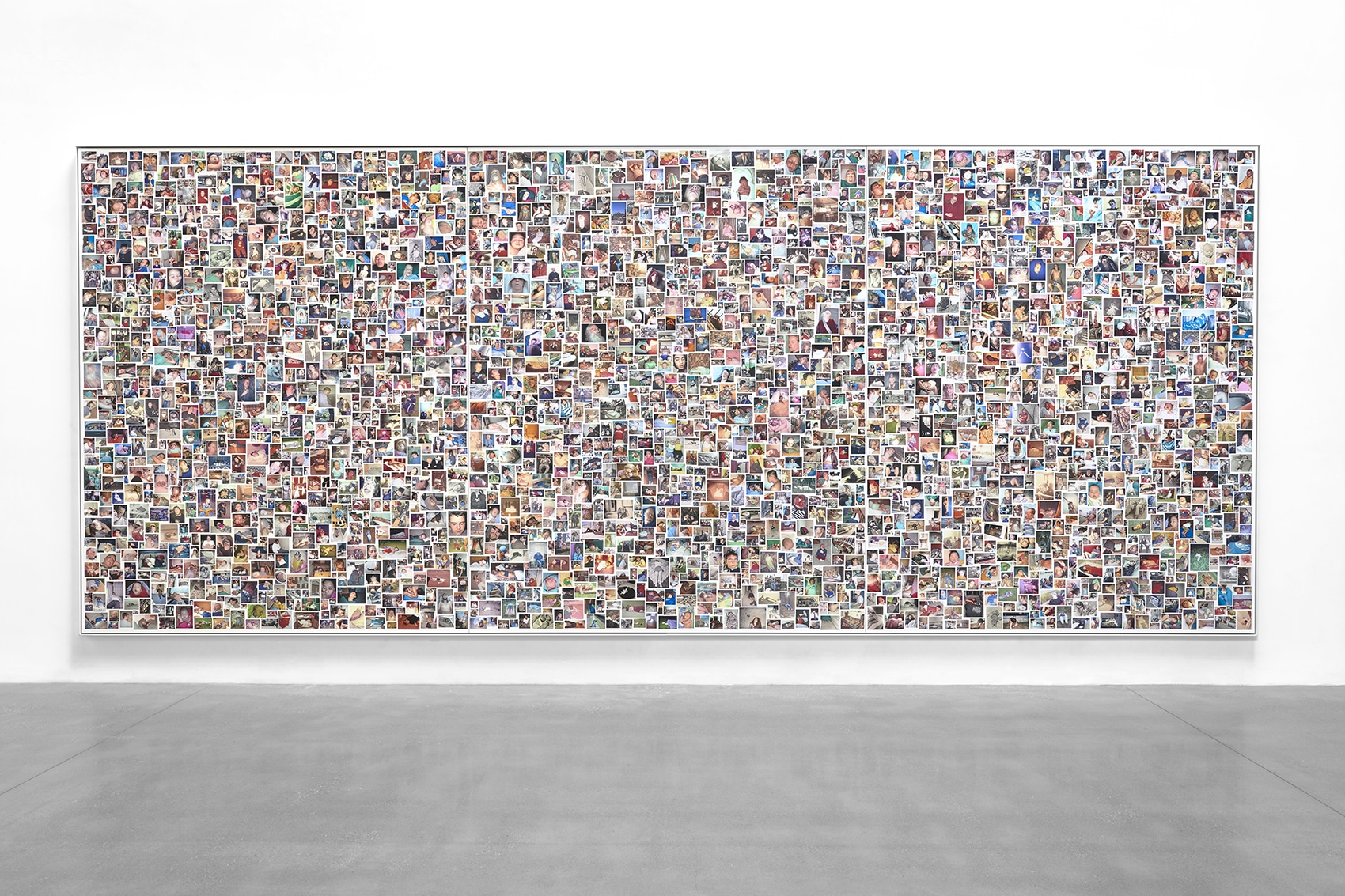 A large rectangular artwork composed of hundreds of small photographs showing people sleeping in different positions and settings, displayed on a white gallery wall.