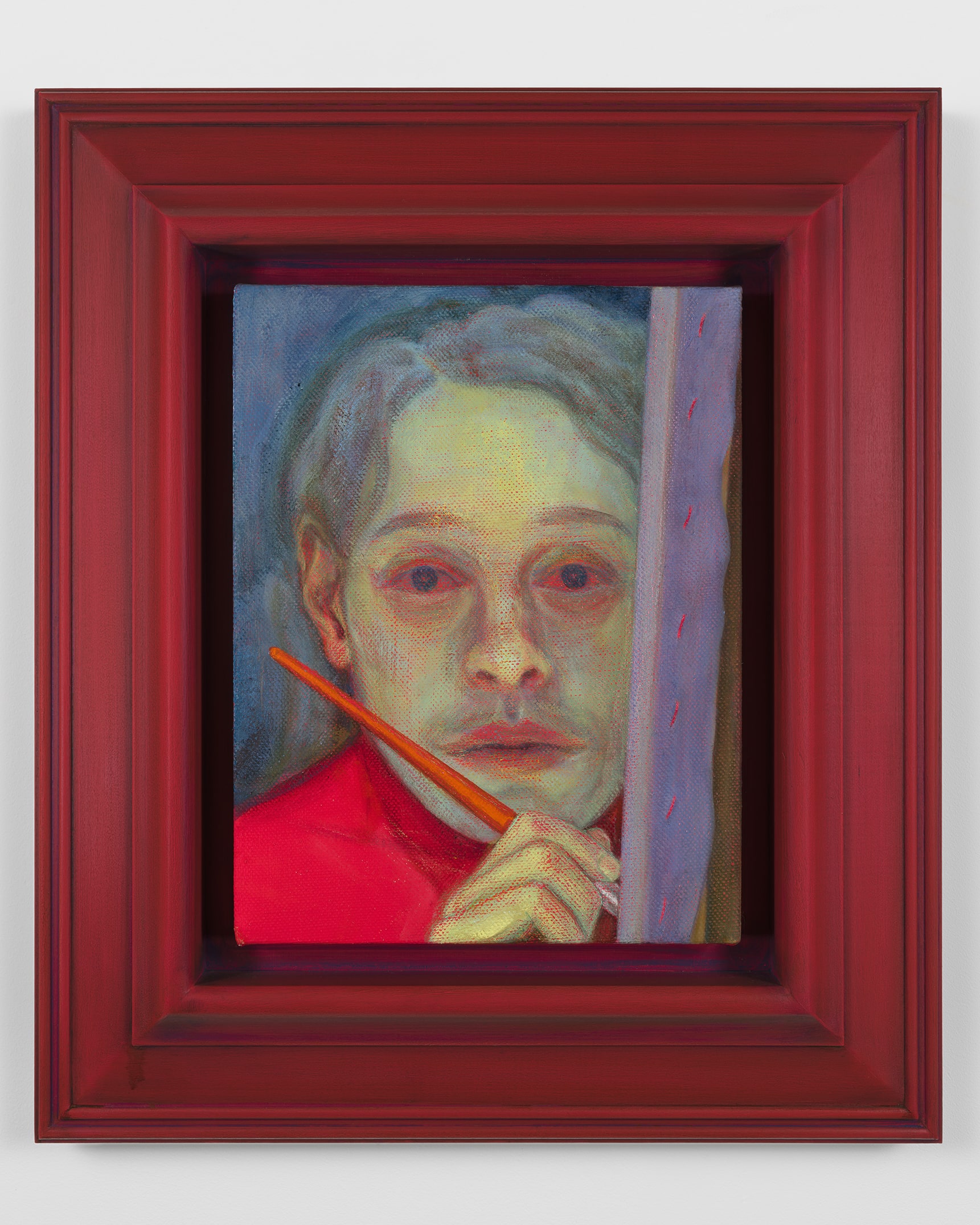 A portrait painting of a pale-faced figure in red holding an orange paintbrush against their cheek, rendered in textured greens, blues and pinks within a deep red wooden frame.
